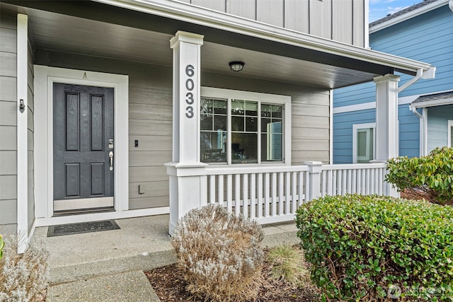 entrance to property featuring a porch and board and batten siding