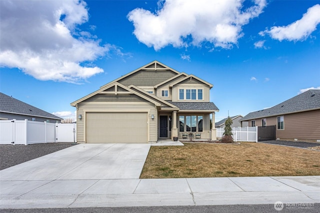 craftsman inspired home featuring a garage, concrete driveway, a front yard, and fence