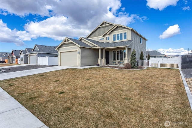 view of front of property featuring driveway, a residential view, fence, and a front lawn