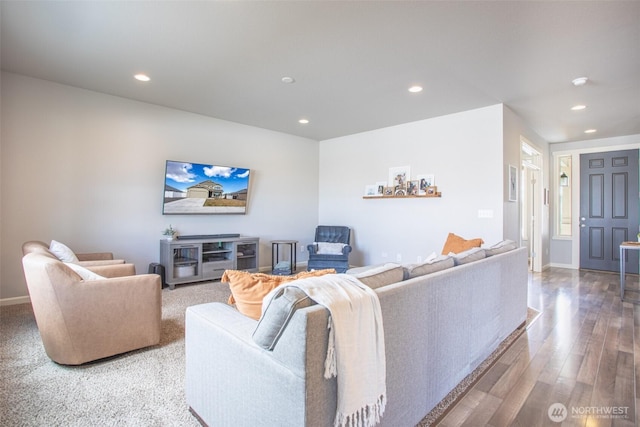 living area with baseboards, wood finished floors, and recessed lighting