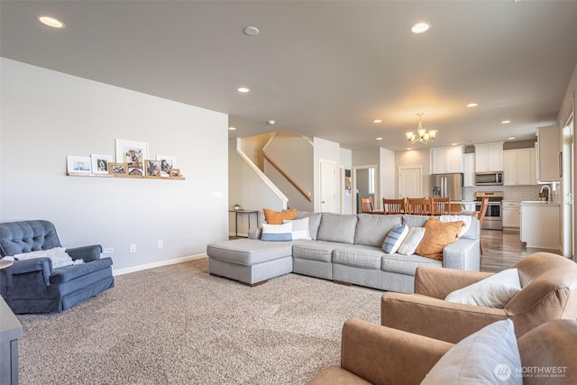 living area featuring an inviting chandelier, stairway, and recessed lighting