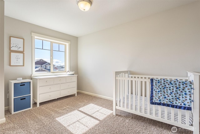 carpeted bedroom featuring a crib and baseboards