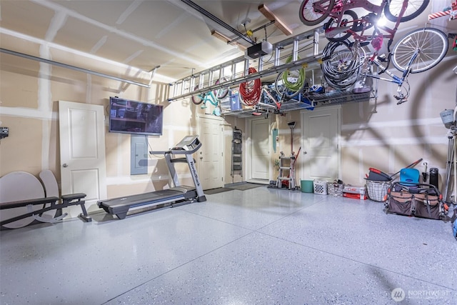 garage featuring electric panel and a garage door opener