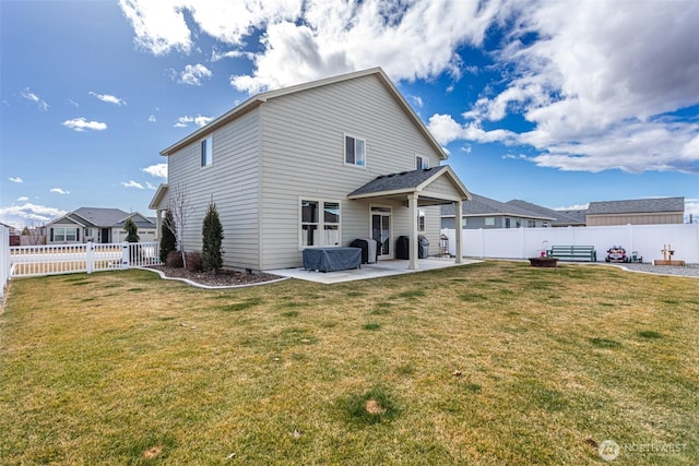 back of property featuring a fenced backyard, a lawn, and a patio