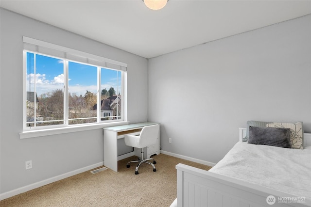 bedroom with carpet floors, visible vents, and baseboards