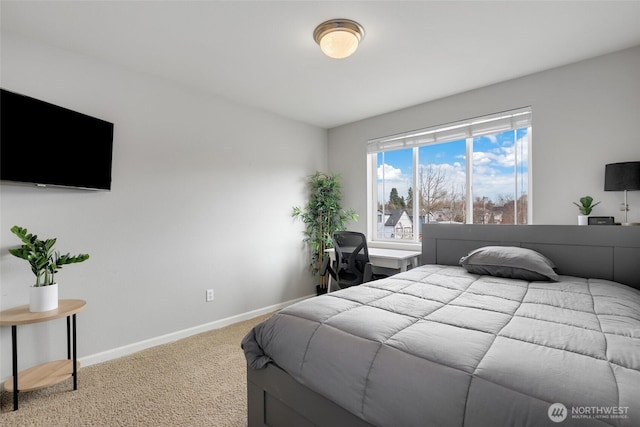 carpeted bedroom featuring baseboards