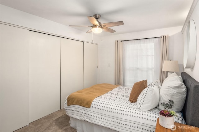 bedroom with a closet, light colored carpet, and ceiling fan