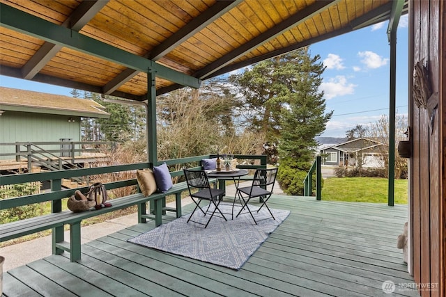 wooden terrace featuring outdoor dining area