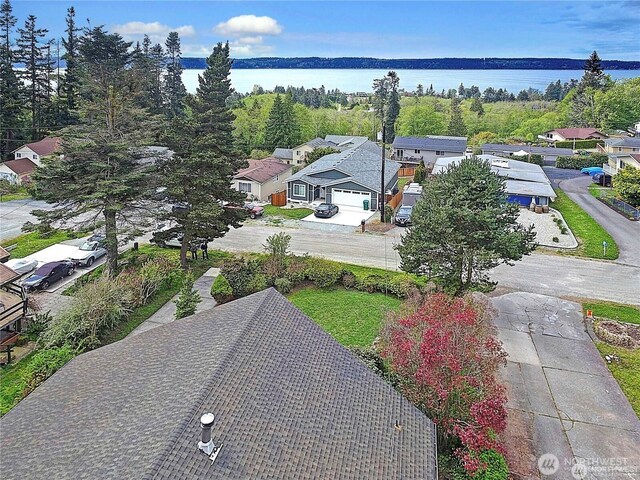 birds eye view of property featuring a water view and a residential view