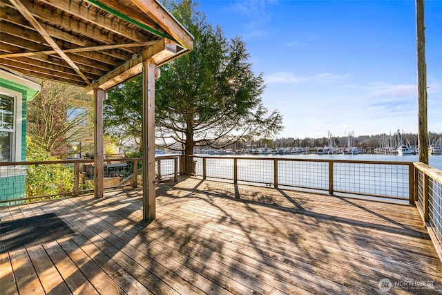 wooden deck featuring a water view