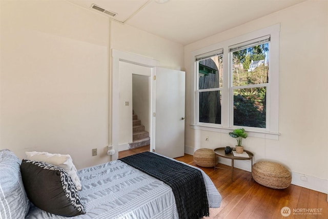 bedroom featuring hardwood / wood-style flooring and visible vents