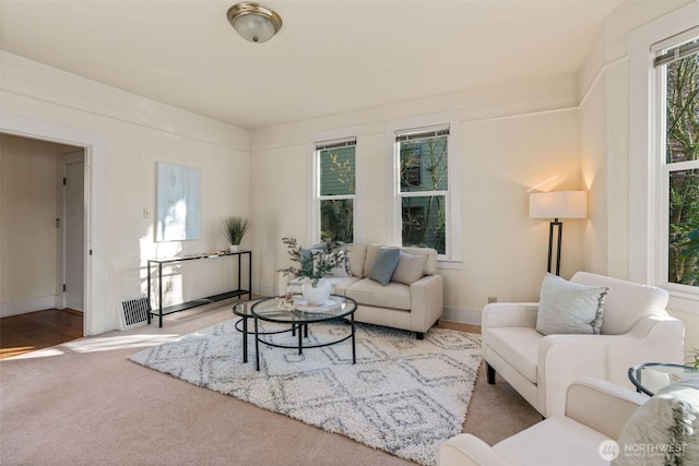 carpeted living area featuring visible vents