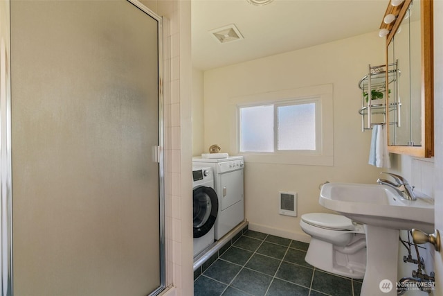 full bathroom with toilet, a stall shower, washing machine and dryer, and tile patterned flooring