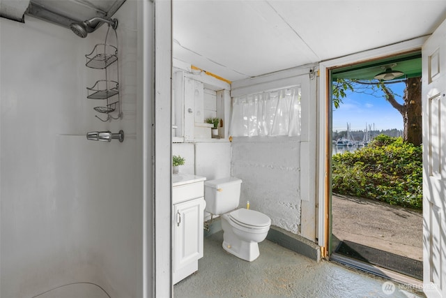 full bath featuring concrete flooring, a shower, vanity, and toilet