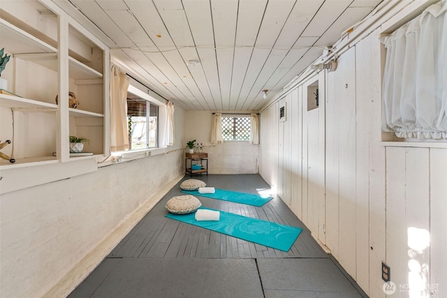 workout room featuring wooden ceiling