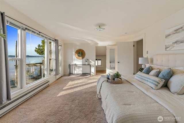 carpeted bedroom with multiple windows, baseboard heating, and access to exterior