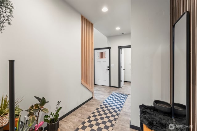 corridor with recessed lighting, visible vents, light wood-style flooring, and baseboards