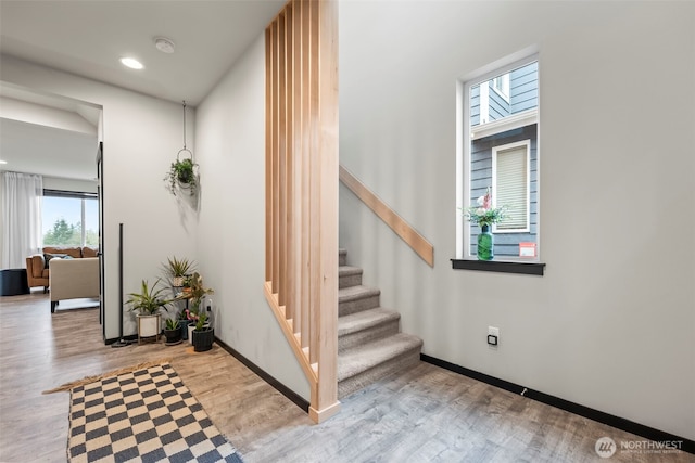 stairs featuring recessed lighting, wood finished floors, and baseboards