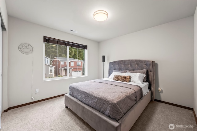 bedroom with visible vents, baseboards, and carpet flooring