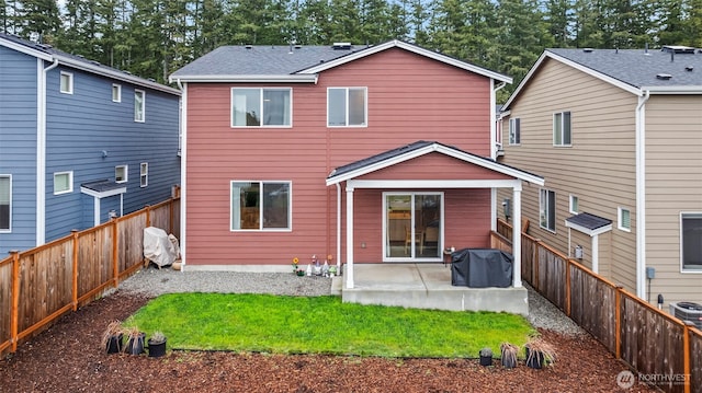 back of property with a patio area, a fenced backyard, and a yard