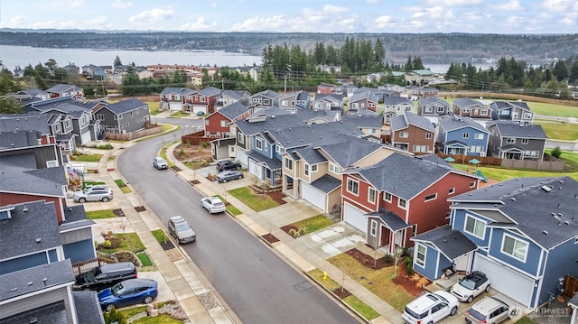 birds eye view of property with a residential view and a water view