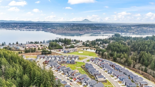 birds eye view of property with a water view and a residential view