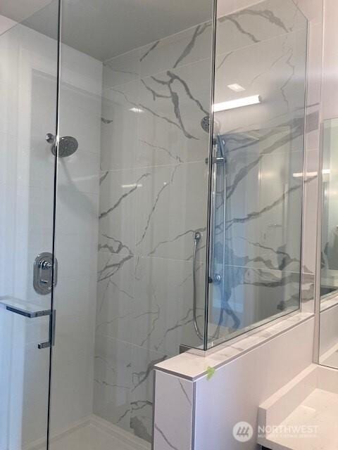 full bath with a marble finish shower