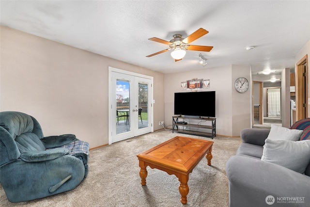 living room with carpet, a ceiling fan, baseboards, french doors, and a textured ceiling