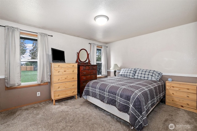 carpeted bedroom featuring a textured ceiling