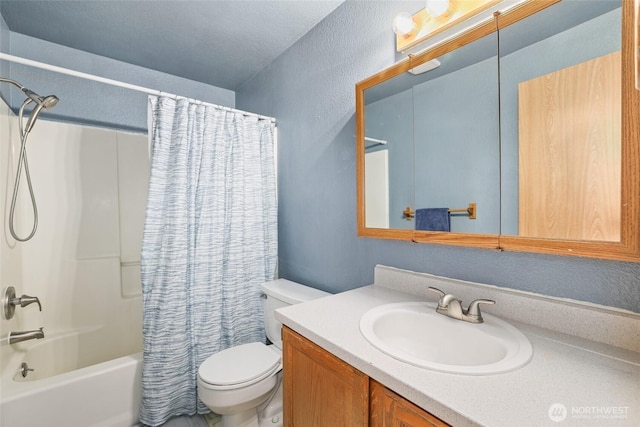 bathroom featuring vanity, toilet, shower / bathtub combination with curtain, and a textured wall