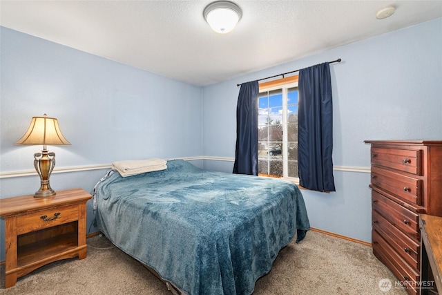 bedroom with baseboards and carpet floors