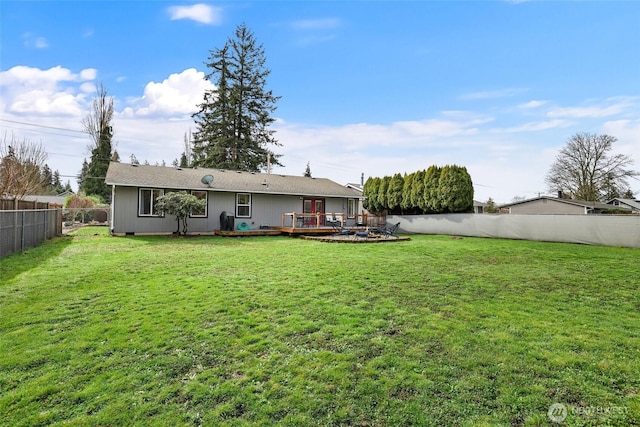 view of yard with a wooden deck and a fenced backyard