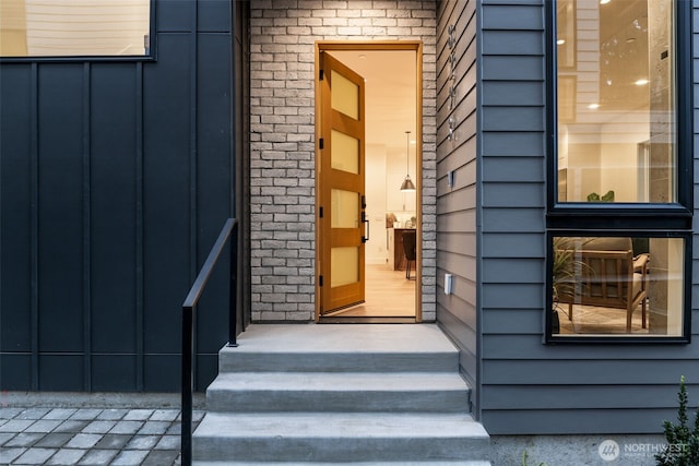 entrance to property featuring brick siding