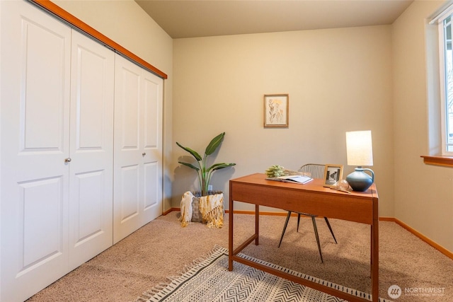 home office with light carpet, plenty of natural light, and baseboards