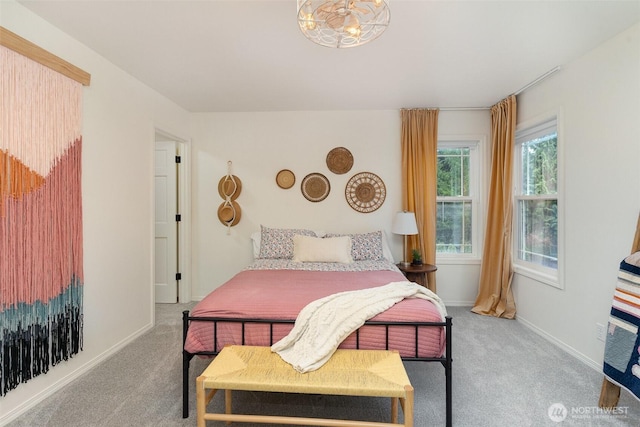 carpeted bedroom featuring baseboards