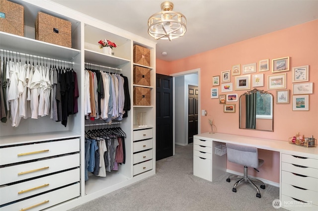 office featuring baseboards, an inviting chandelier, and light colored carpet