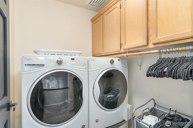 laundry room featuring cabinet space, visible vents, and separate washer and dryer