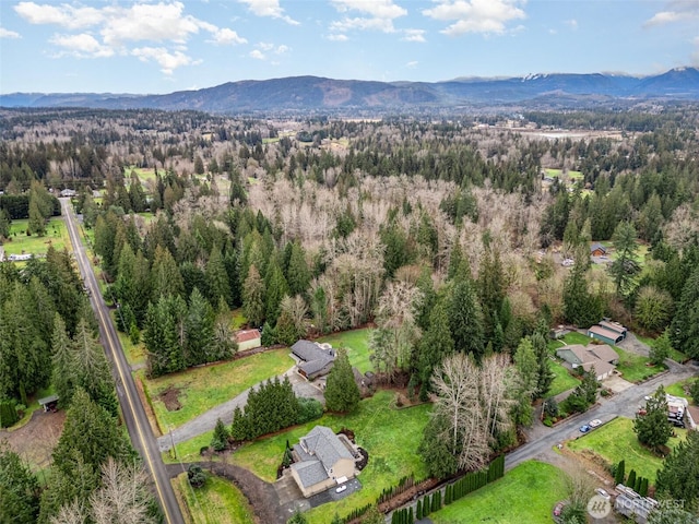 bird's eye view with a forest view and a mountain view