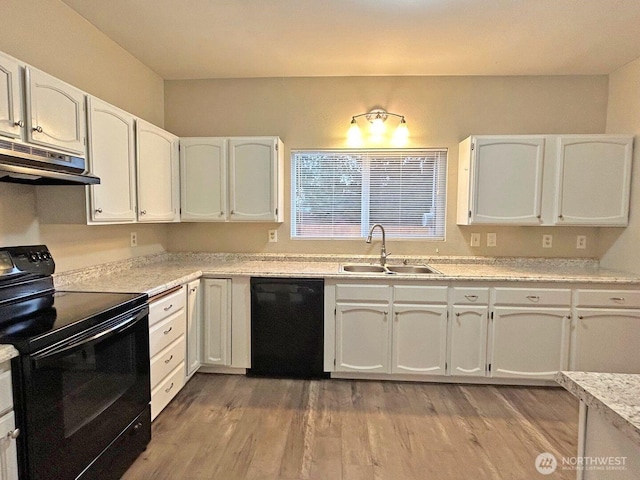 kitchen with white cabinets, under cabinet range hood, light countertops, black appliances, and a sink