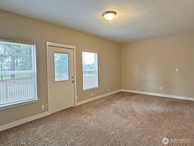 doorway to outside featuring carpet and baseboards