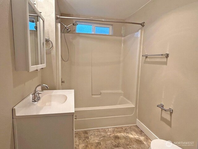 full bathroom featuring shower / bath combination, baseboards, toilet, and vanity