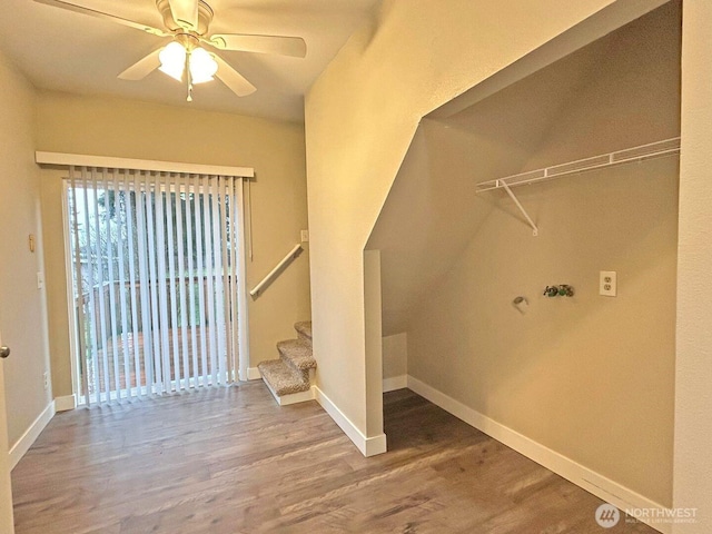 clothes washing area with ceiling fan, baseboards, and wood finished floors