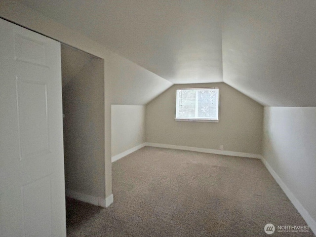 bonus room featuring vaulted ceiling, carpet, and baseboards