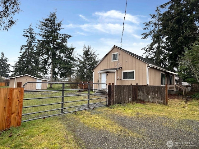 exterior space with a garage, a gate, and fence