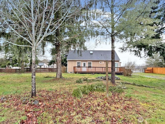 view of yard featuring a deck and fence