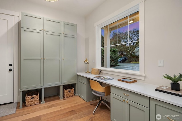 office featuring light wood finished floors and built in study area