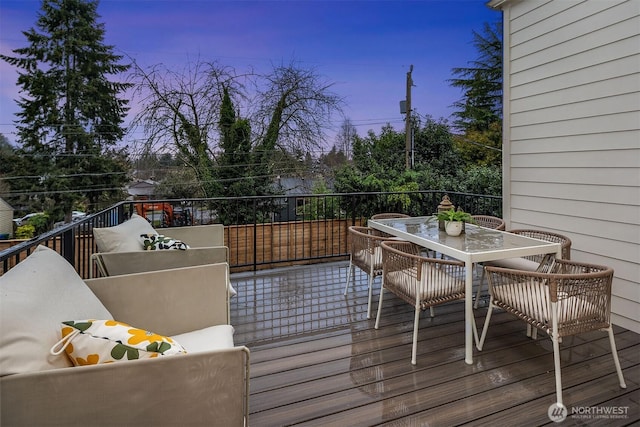 wooden terrace featuring outdoor dining area