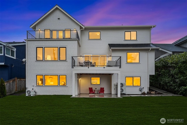 rear view of property featuring ac unit, a patio, a balcony, and a lawn