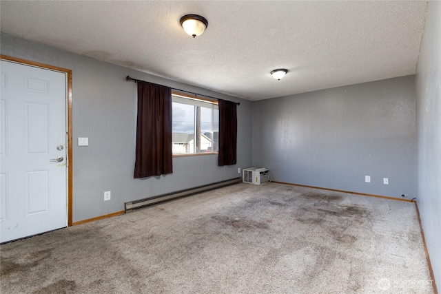 empty room featuring a textured ceiling, light colored carpet, a baseboard heating unit, baseboards, and a wall mounted air conditioner