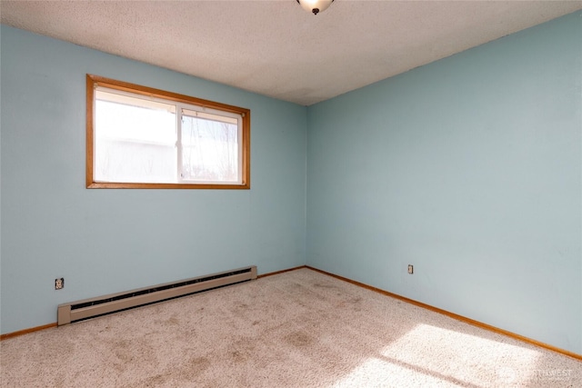 empty room with carpet, a baseboard radiator, baseboards, and a textured ceiling